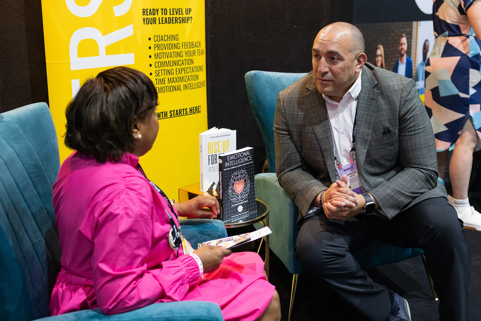 Two professionals in conversation at a leadership conference